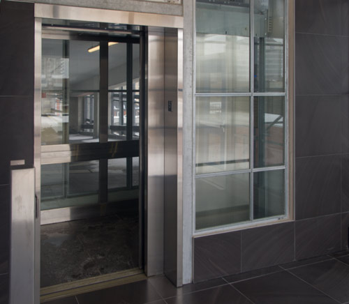 Elevator with glass cab in a parking garage