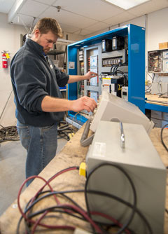 Mechanic testing an elevator controller