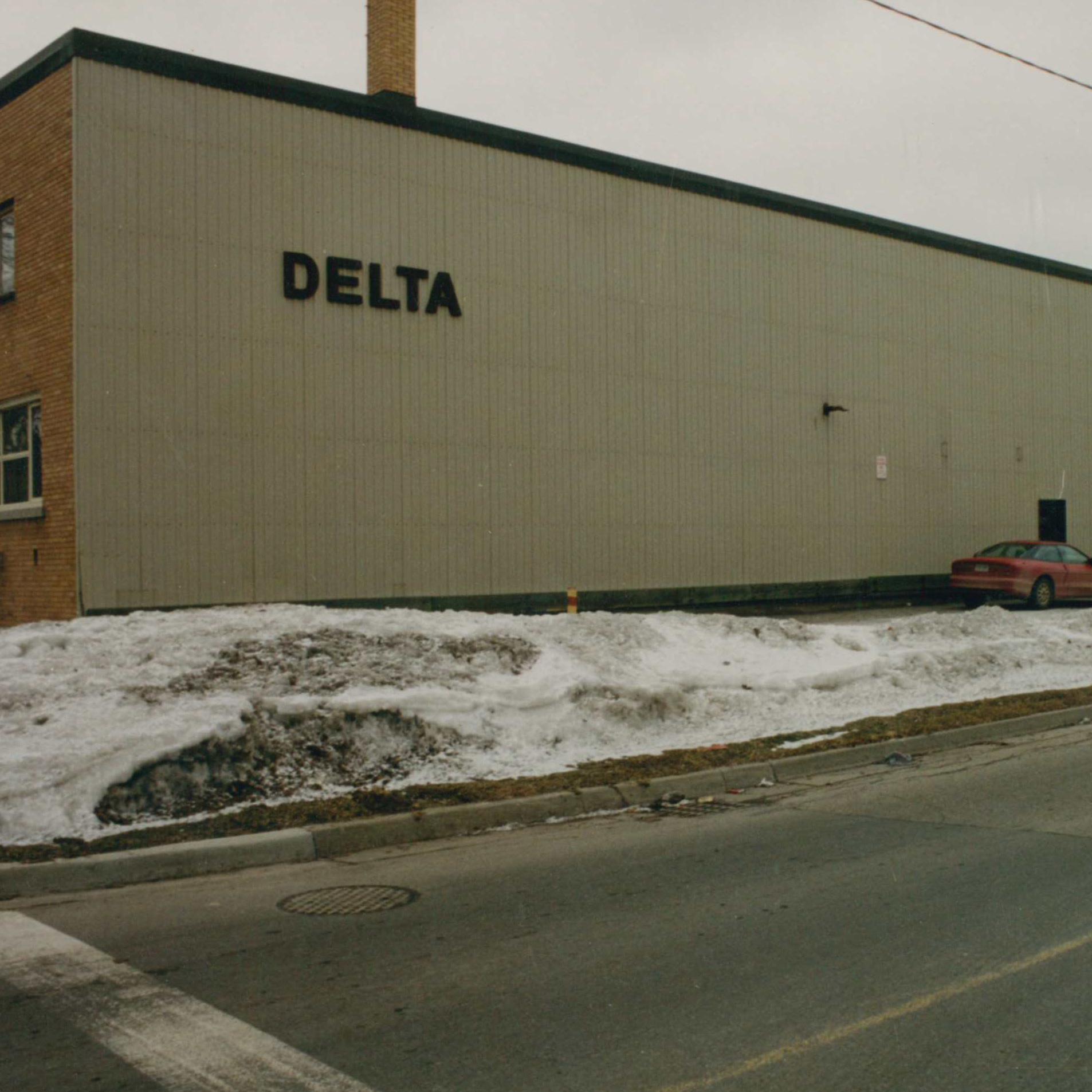 Delta Elevator Office at 97 Leger St - large beige building, snow on the ground in front